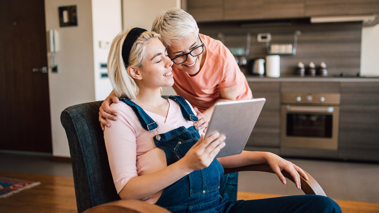 mother and daughter looking at the digital tablet